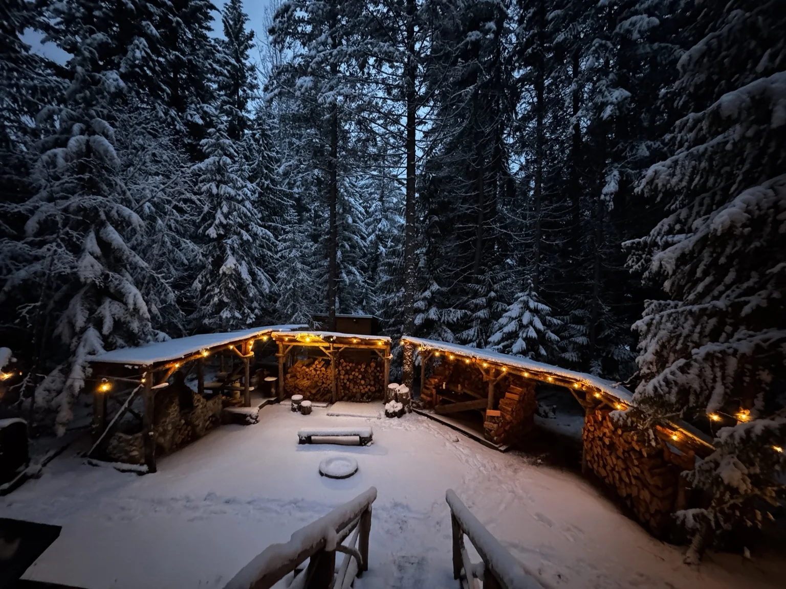 Fresh snow in the Camp Moose Trail courtyard beneath glowing lights